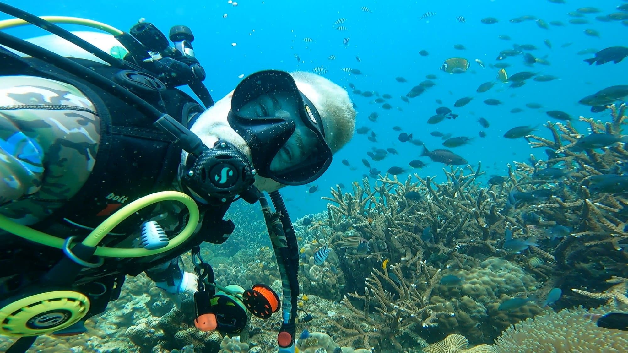 Dominic Frei diving over coral reef in Bali — founder of Boutique Diving Bali
